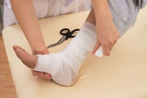 wound care specialist wrapping injured ankle