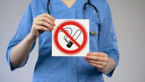 doctor holding a no smoking sign