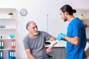 older patient getting his wound dressed by specialist