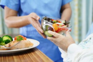 doctor giving nutritional meal to patient