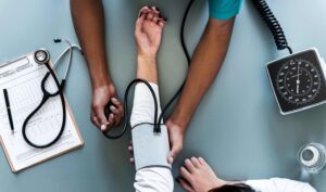 wound care specialist measuring patient’s blood pressure