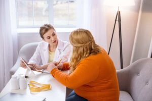 wound specialist discussing obesity with overweight patient