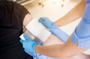 specialist keeping wound moist with dressings